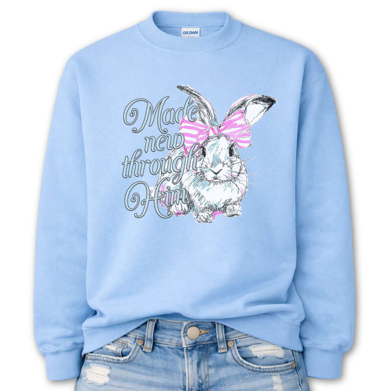 light blue Bold Christian graphic on a Gildan crewneck sweatshirt. The design features a fawn with soft brown detailing and a large pink bow, paired with the phrase “Wildly Loved” in blush vintage-style lettering. 