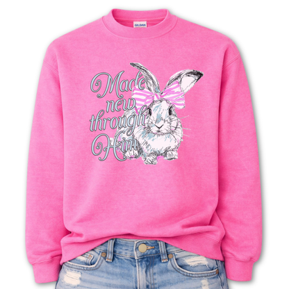Pink Bold Christian graphic on a Gildan crewneck sweatshirt. The design features a fawn with soft brown detailing and a large pink bow, paired with the phrase “Wildly Loved” in blush vintage-style lettering. 