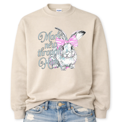 beige Bold Christian graphic on a Gildan crewneck sweatshirt. The design features a fawn with soft brown detailing and a large pink bow, paired with the phrase “Wildly Loved” in blush vintage-style lettering. 
