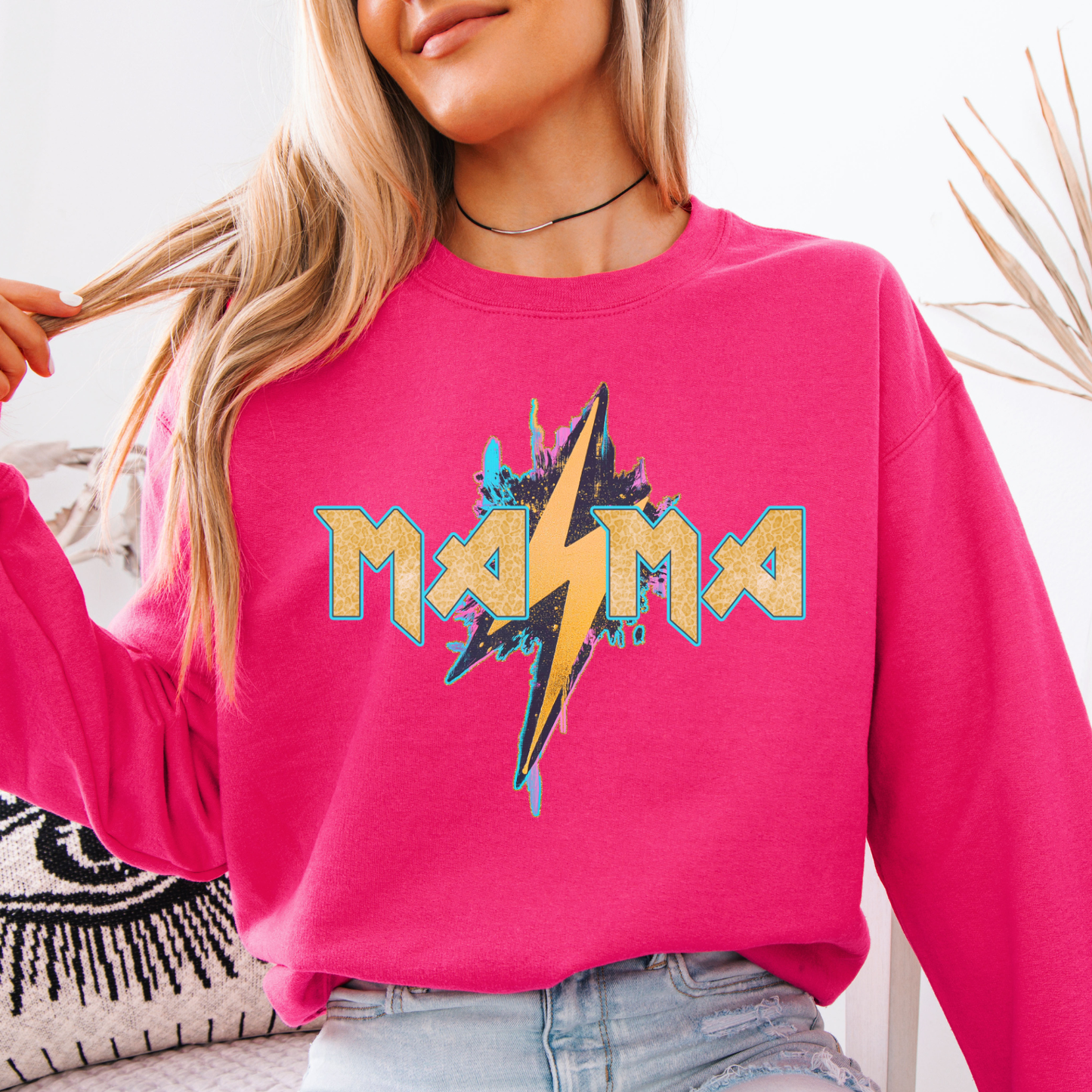 Mama graphic desing with large lightning bolt on a pink sweastshirt