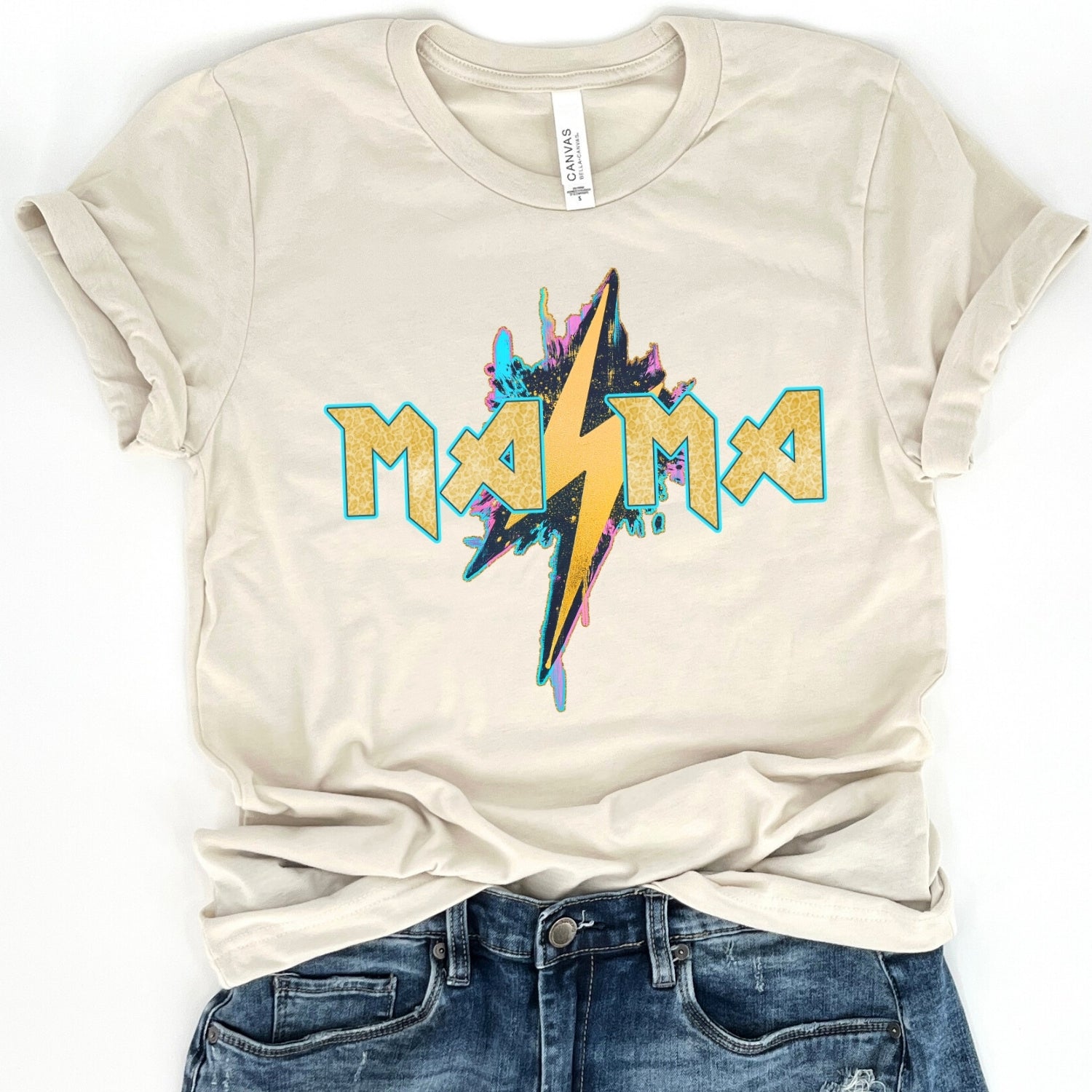 beige t-shirt with 'Mama' lightning bolt graphic design on a white background