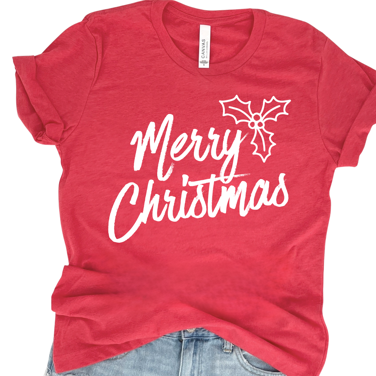 A classic Merry Christmas graphic with a simple holly detail for an easy, timeless holiday look on a heather red tee