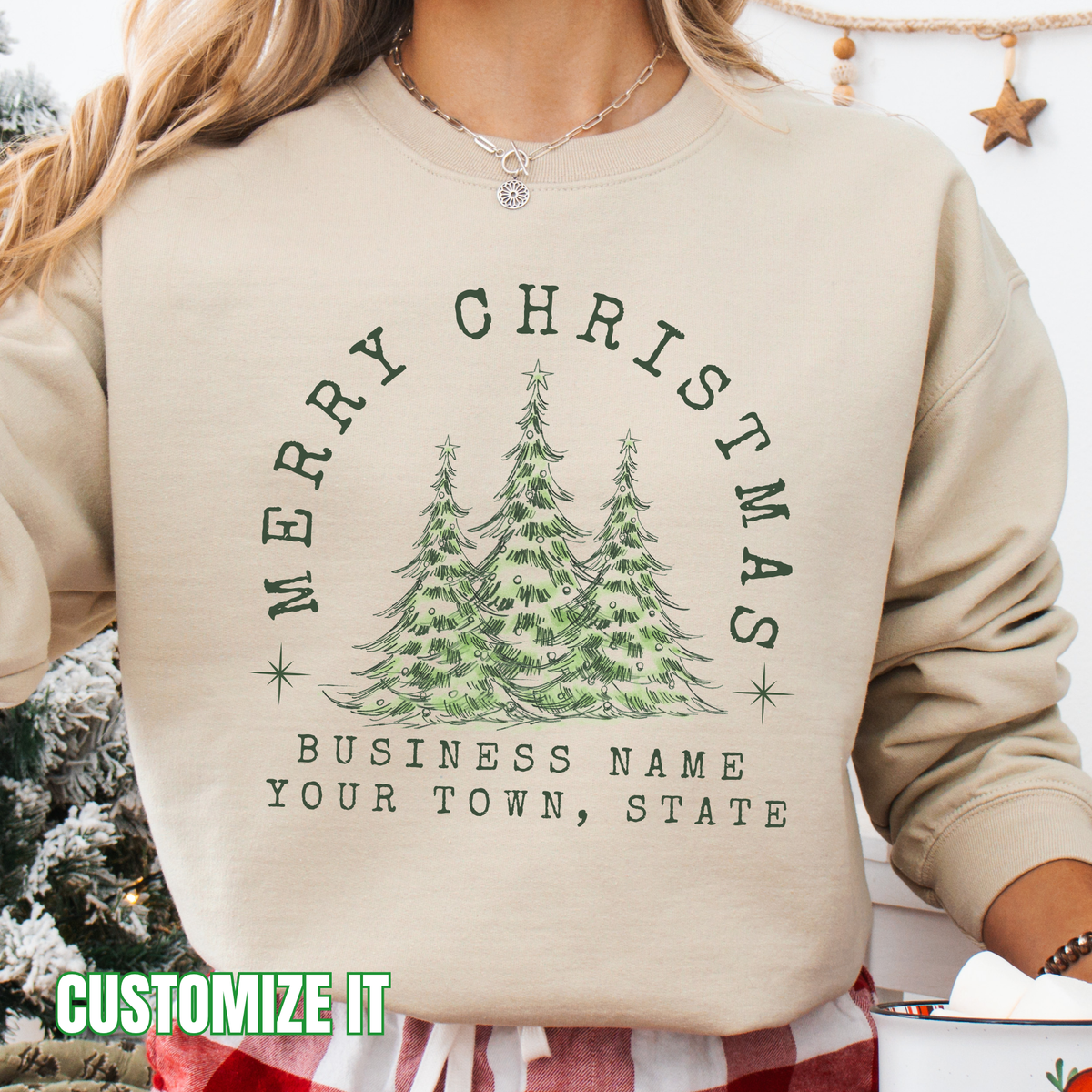 Merry Christmas customizable graphic sand sweatshirt with 3 outdoor christmas trees that say Merry Christmas arching over the trees