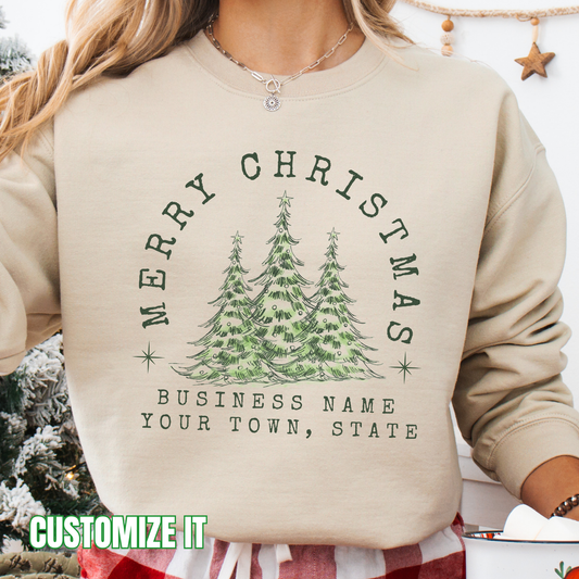 Merry Christmas customizable graphic sand sweatshirt with 3 outdoor christmas trees that say Merry Christmas arching over the trees