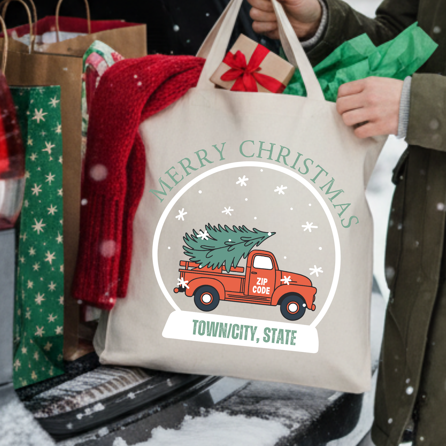 Canvas tote bag with a red truck carrying a Christmas tree in. snow globe.  Personalize it.