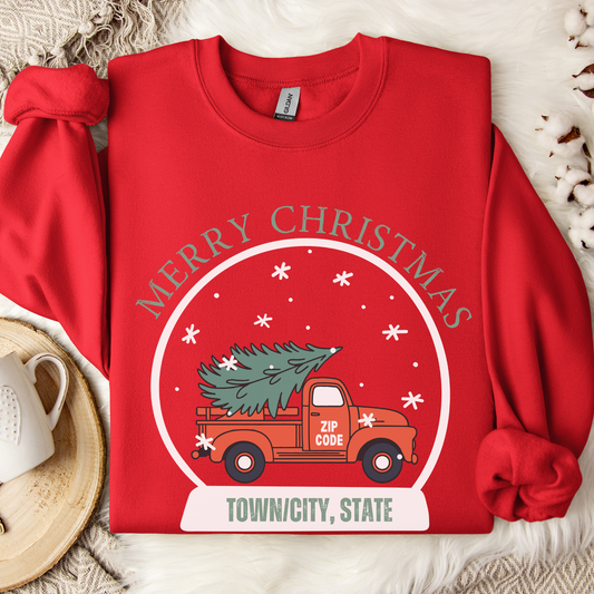 snow globe of a vintage red truck with a Christmas tree in the back that you can customize with your zip code, business name, city and state, or shop small.  Red sweatshirt