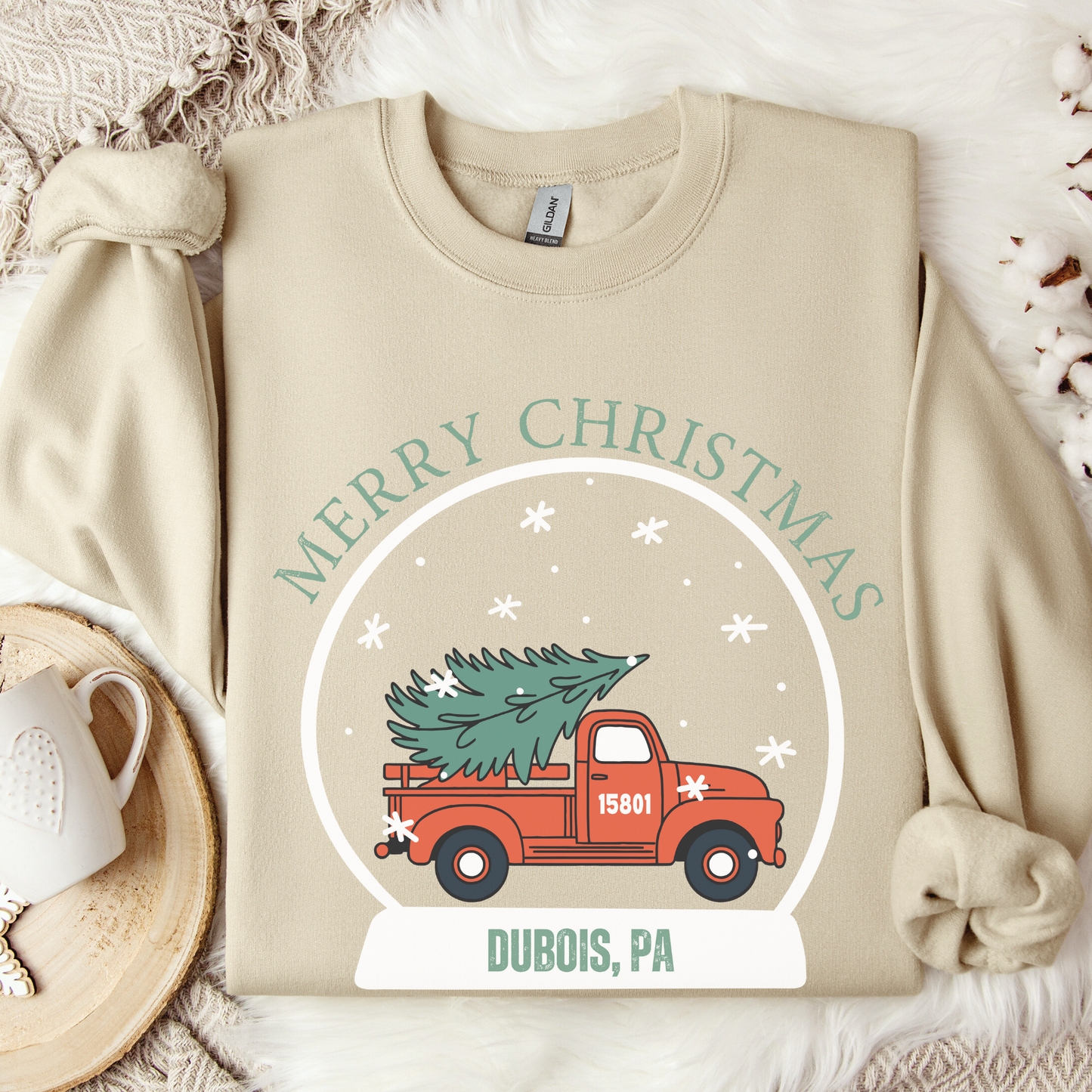 snow globe of a vintage red truck with a Christmas tree in the back that you can customize with your zip code, business name, city and state, or shop small.  
Beige sweatshirt