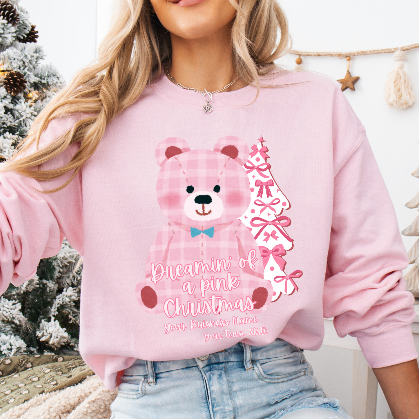 oversize pink plaid teddybear with white Christmas tree with pink bows on a light pink sweatshirt. Text says Dreamin of a pink Christmas Customize with business name, city, state or both.
