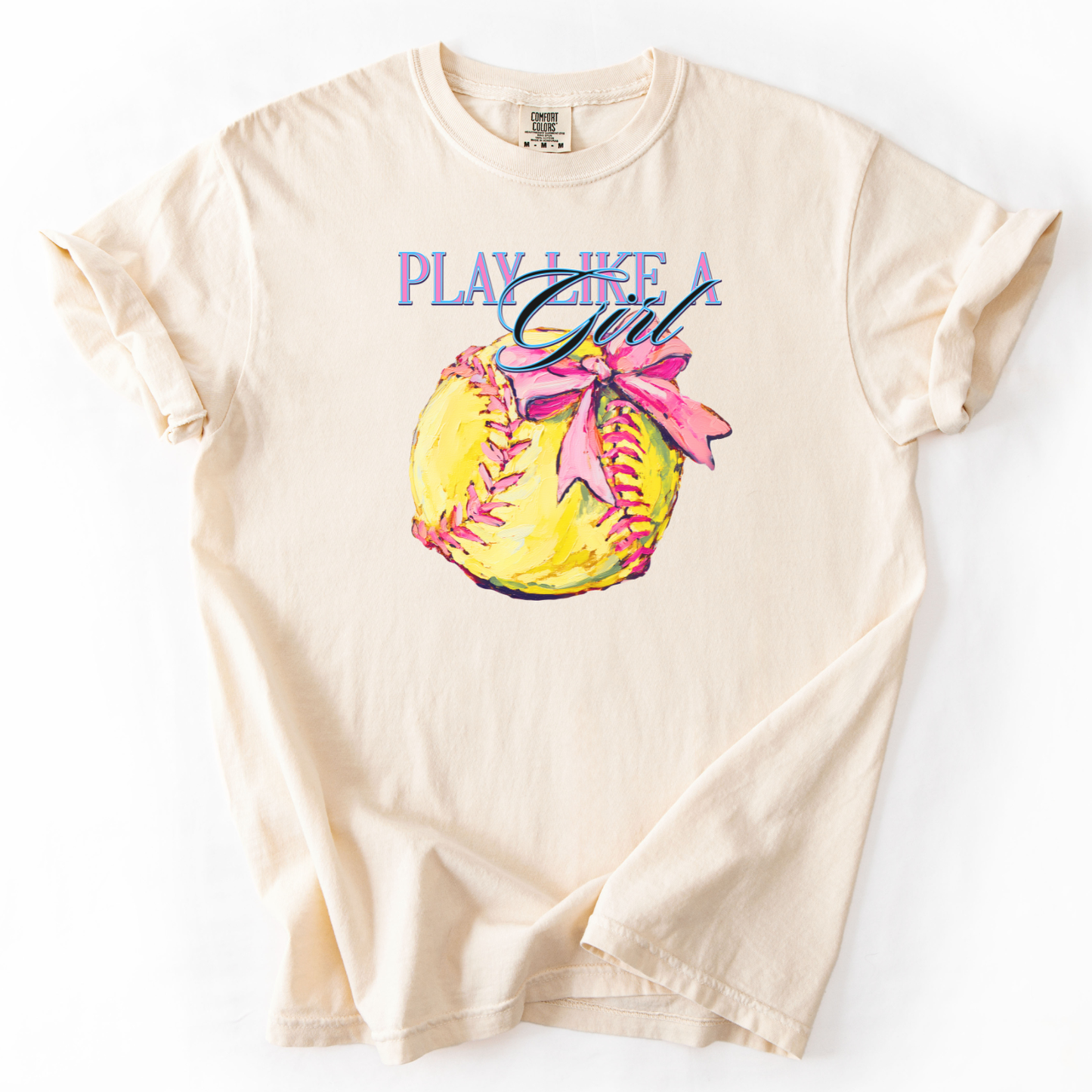 ivory t-shirt with a graphic of a softball and text 'Play Like a Girl' on a white background