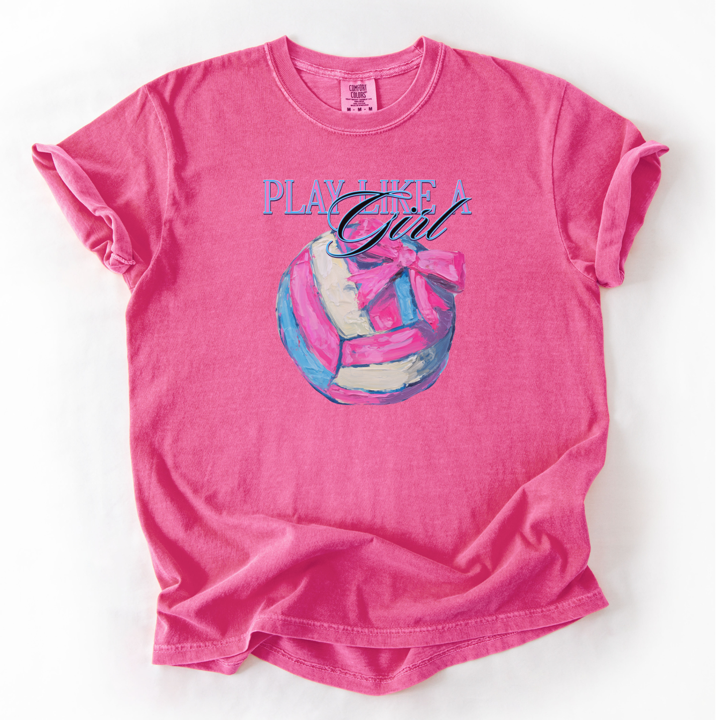 Play like a girl pink blue and white volleyball graphic with a bow on an crunchberry comfort colors tee