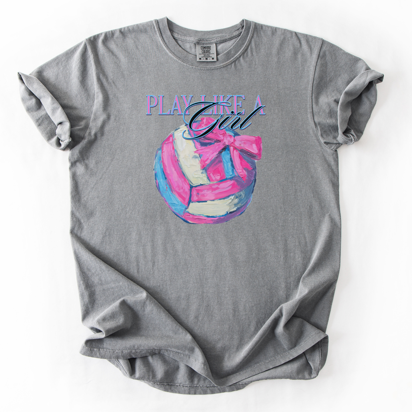 Play like a girl pink blue and white volleyball graphic with a bow on a gray comfort colors tee