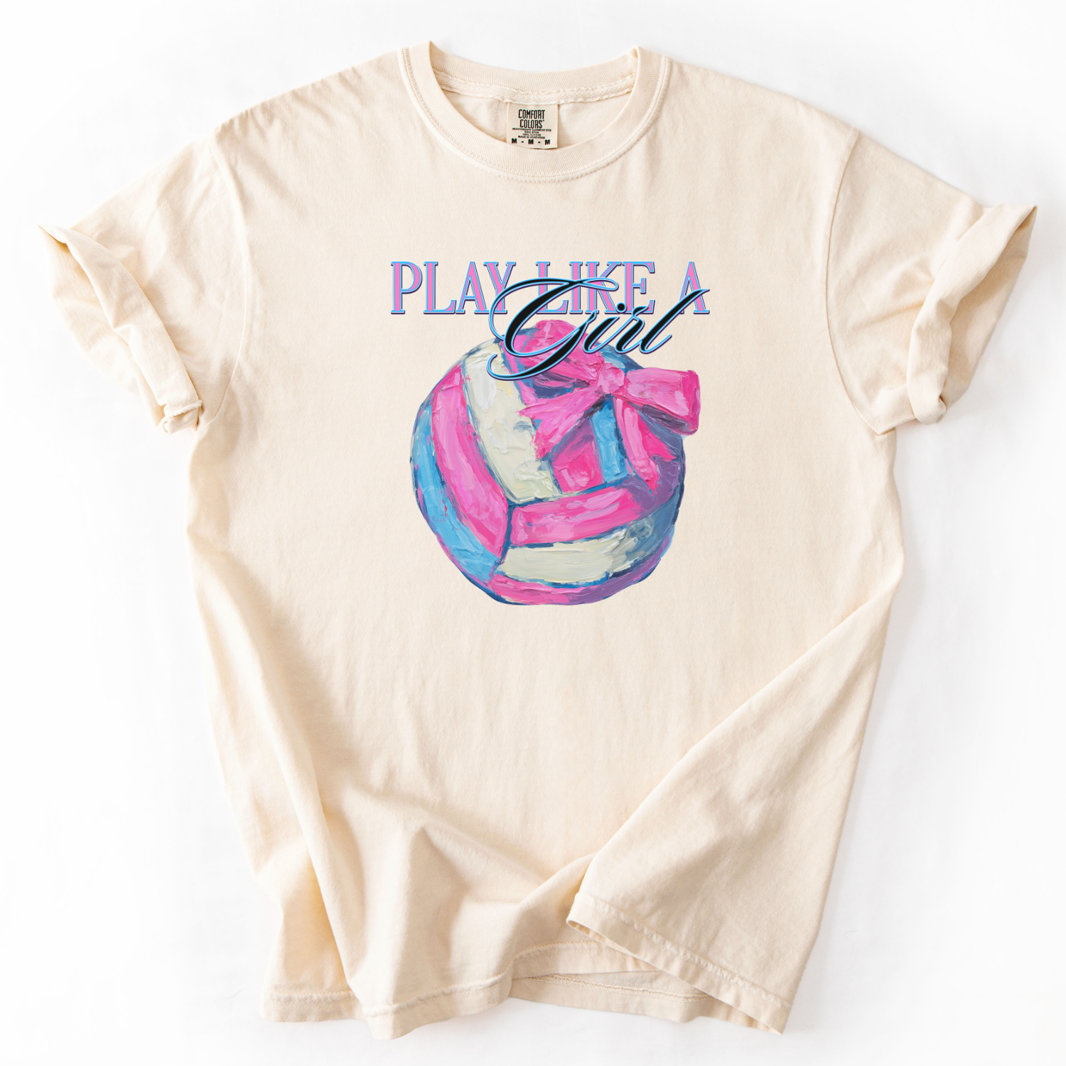 Play like a girl pink blue and white volleyball graphic with a bow on an ivory comfort colors tee