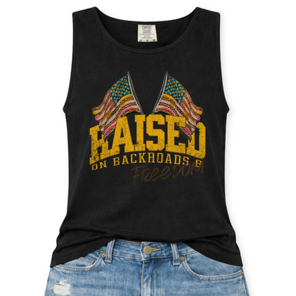 Black tank top with colorful graphic and text 'Raised on Backroads and Freedom' displayed on a white background.
