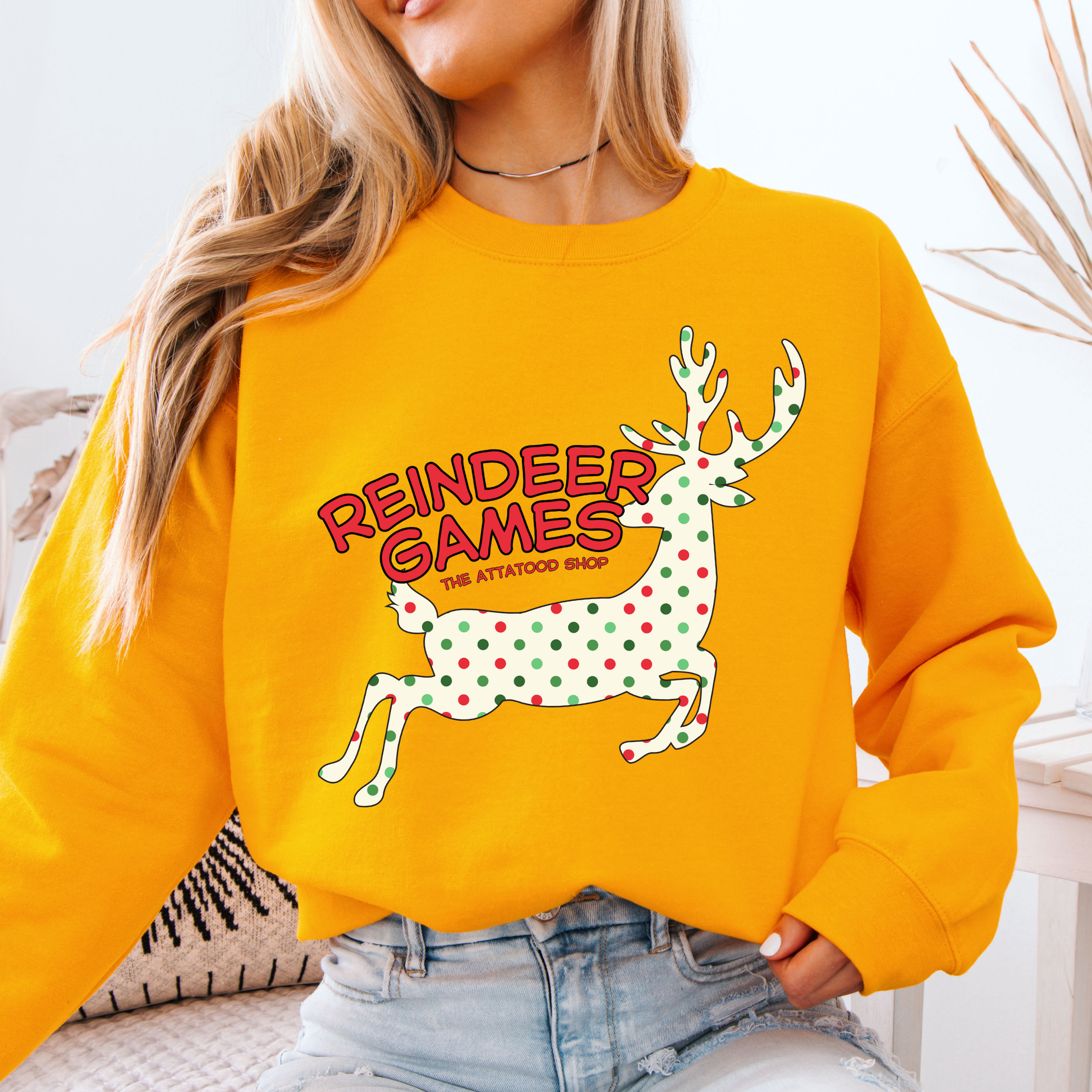 yellow sweatshirt with a polka dot reindeer.  Test says reindeer games.  You can customize the sweatshirt with business name, town and state or both