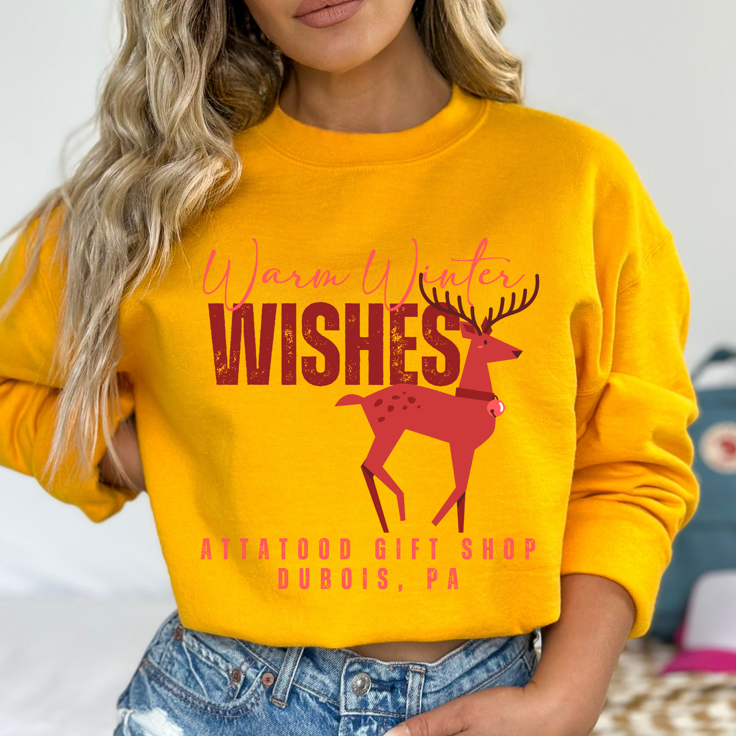 yellow sweatshirt with red reindeer design That says Warm winter wishes in red. Below design is a place to customize the sweatshirt with your business name, town and state or both.
