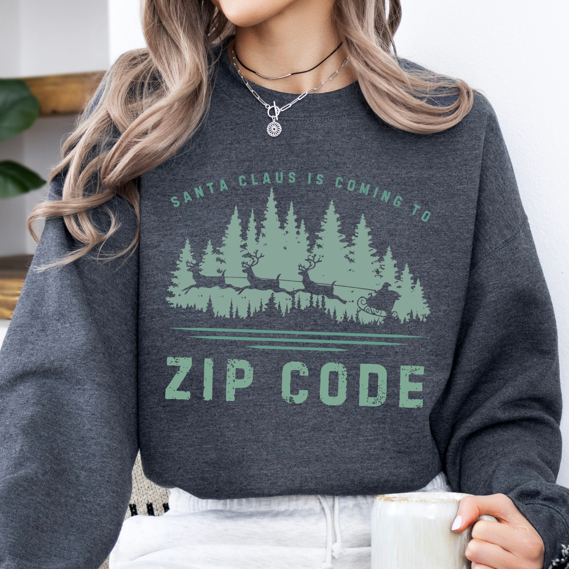 Custom Santa's coming to.  customize your city, state, zip code or business.  Santa's sleigh and reindeer flying over the forest on a dark heather gray sweatshirt.