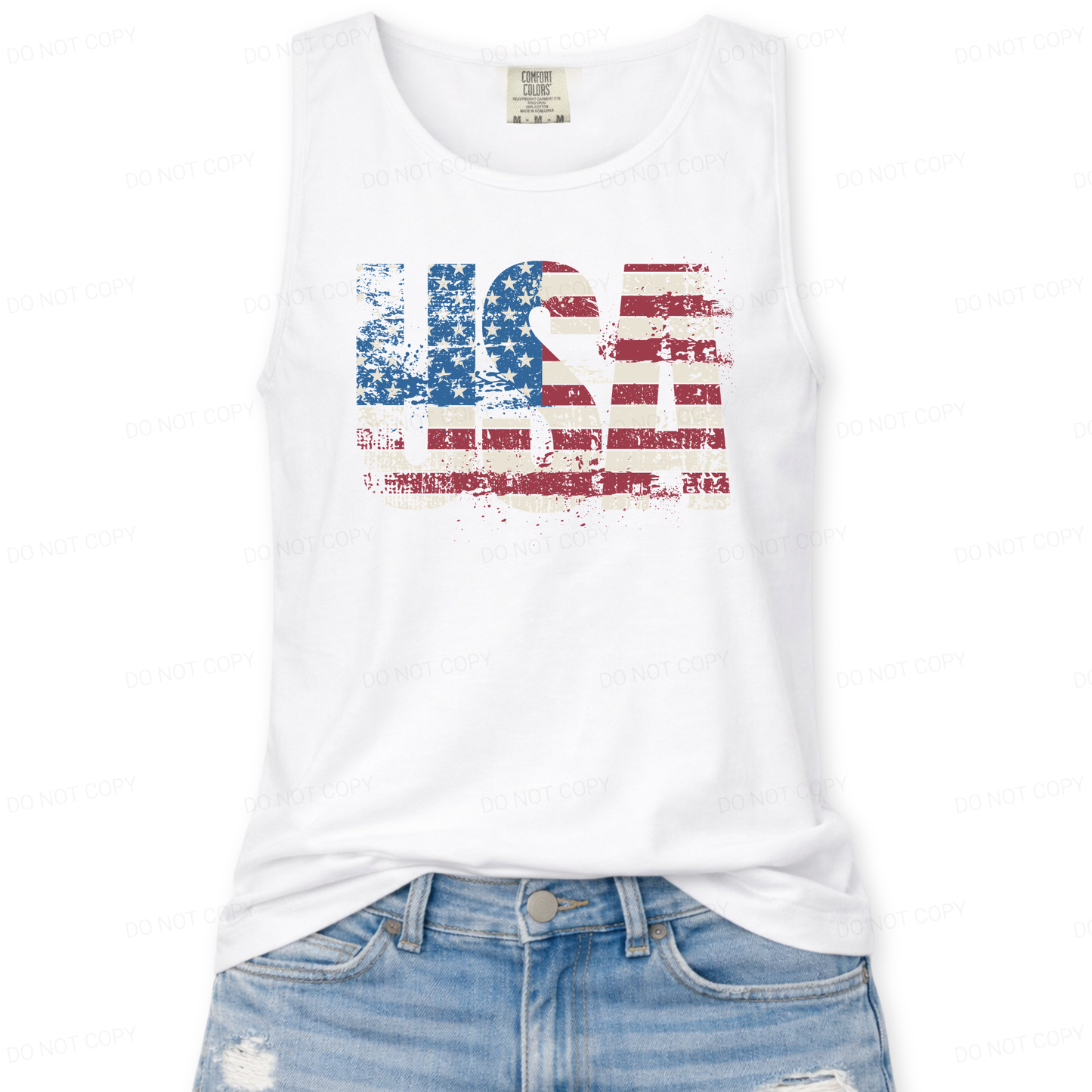 Distressed oversized "USA" overlayed with an American Flag on a Comfort Colors garment dyed unisex white tank top