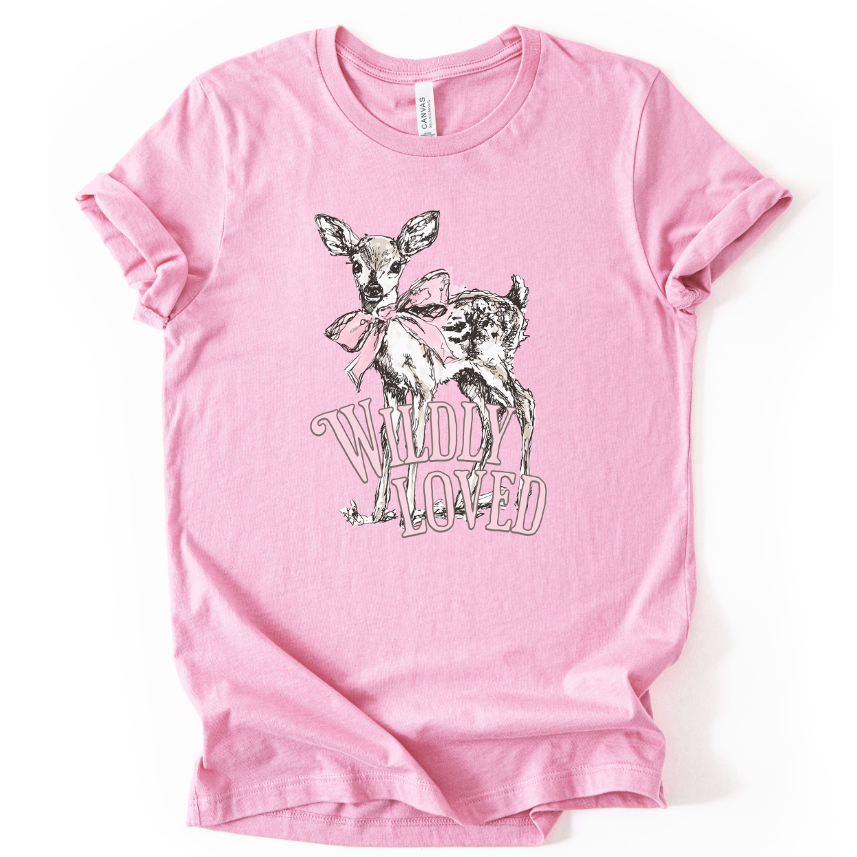 Christian spring cross graphic on a Bella Canvas t-shirt. The design features a greenery-filled cross adorned with a large pink bow, layered with the phrase “Hope Blooms Here” in bold, vintage-inspired lettering. The artwork blends Easter symbolism with soft feminine styling, creating a faith-forward seasonal piece.&nbsp;