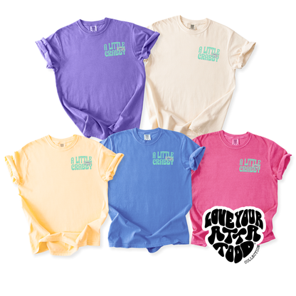 Five colorful t-shirts with a little crabby on the pocket with a crab