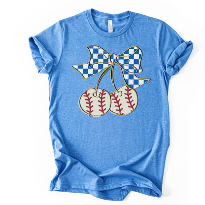 Blue t-shirt with a graphic of cherries and a checkered bow on a white background
