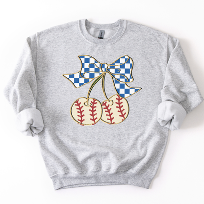 ash crewneck sweatshirt featuring a blue gingham bow tied to two cherry-shaped baseballs with red stitching, styled flat with sleeves scrunched