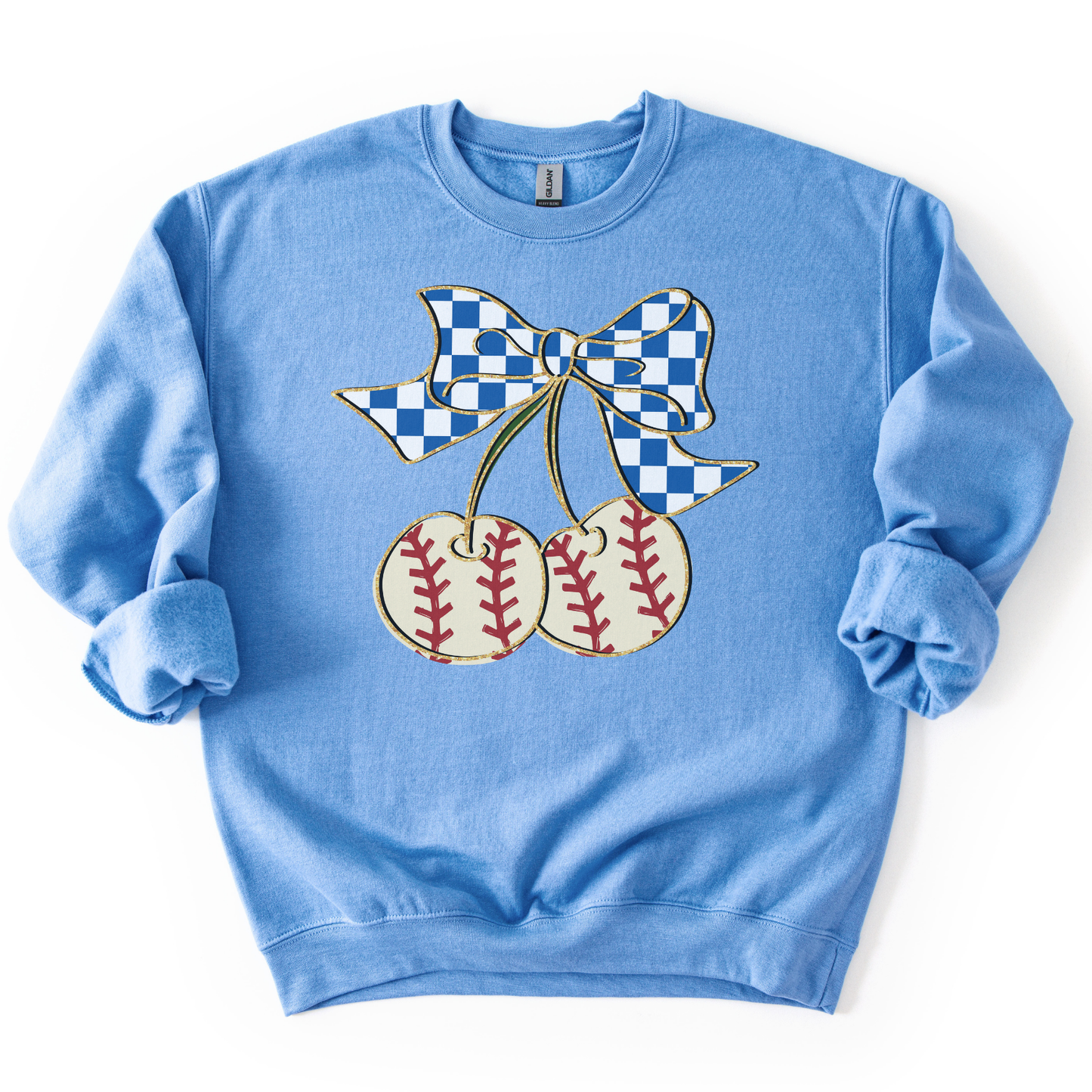 blue crewneck sweatshirt featuring a blue gingham bow tied to two cherry-shaped baseballs with red stitching, styled flat with sleeves scrunched