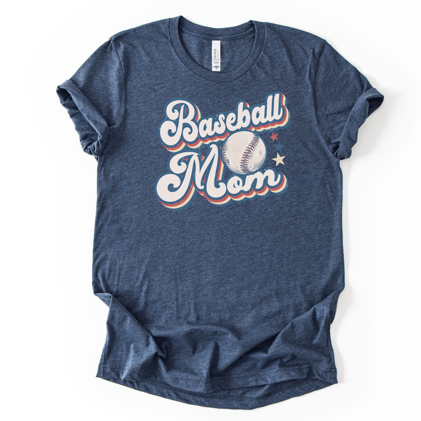 Heather navy graphic t-shirt with retro-style “Baseball Mom” lettering, baseball graphic, and star accents, laid flat with rolled sleeves.