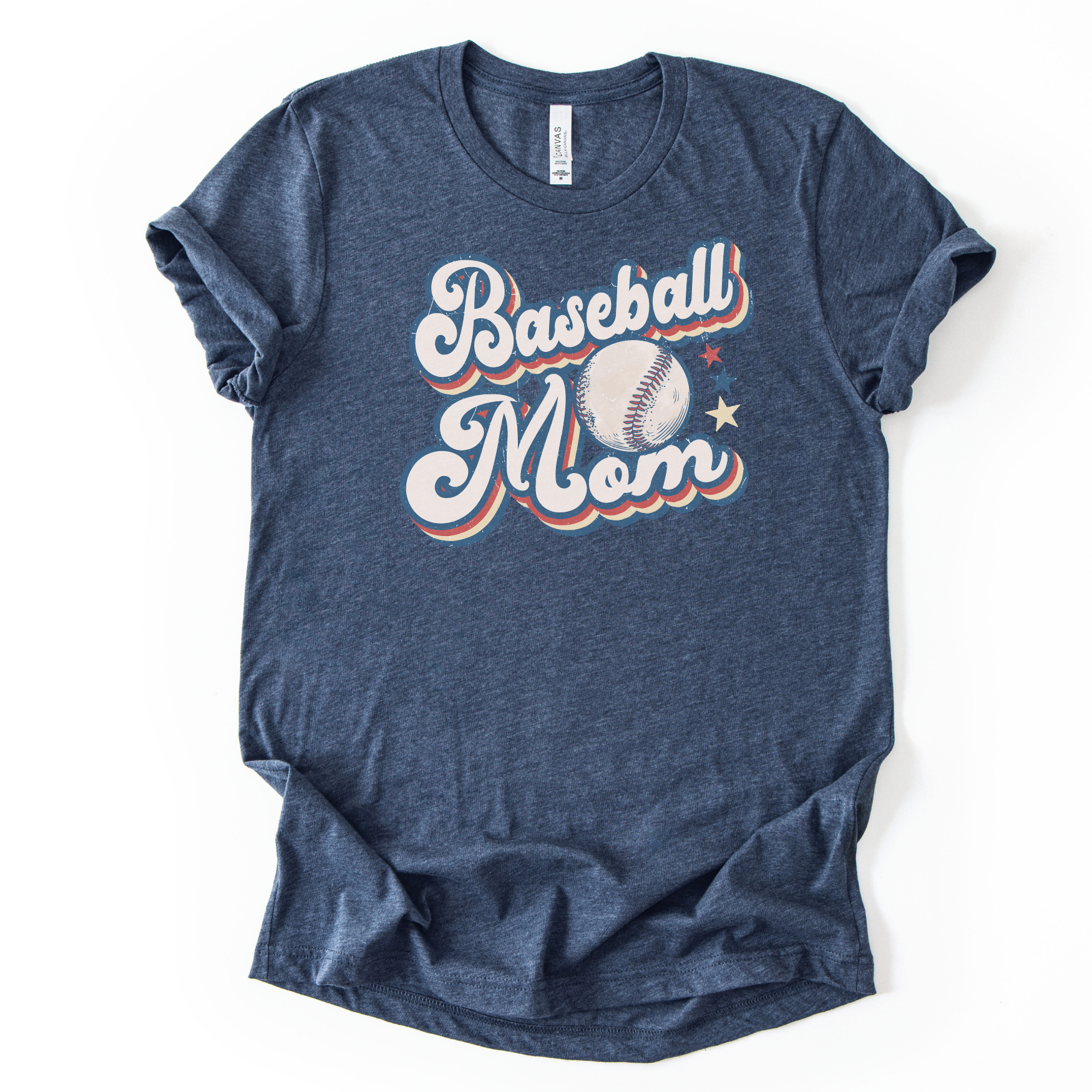 Heather navy graphic t-shirt with retro-style “Baseball Mom” lettering, baseball graphic, and star accents, laid flat with rolled sleeves.