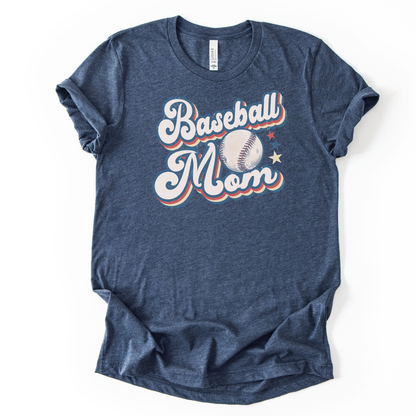 Heather navy graphic t-shirt with retro-style “Baseball Mom” lettering, baseball graphic, and star accents, laid flat with rolled sleeves.