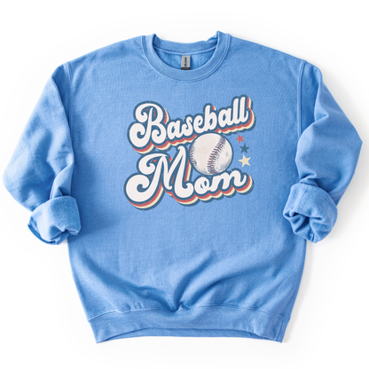 Columbia blue crewneck sweatshirt with retro “Baseball Mom” lettering, baseball graphic, and star accents in red, white, and blue, laid flat.