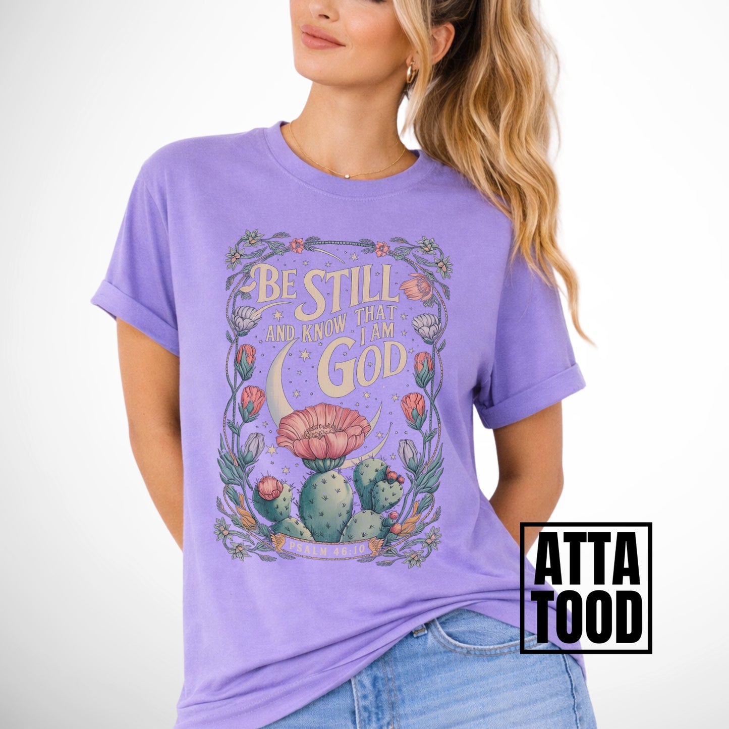 Be still and know that I am God Psalm 46:10 .  an oversized blooming cactus plant on  an violet comfort colors tee