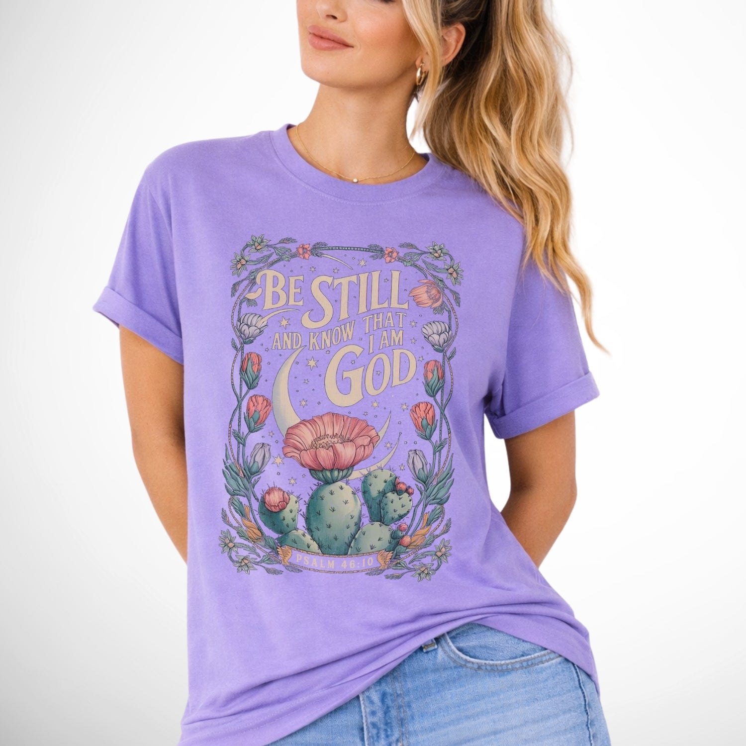 Be still and know that I am God Psalm 46:10 .  an oversized blooming cactus plant on  an violet purple comfort colors tee