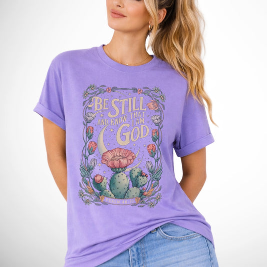 Be still and know that I am God Psalm 46:10 .  an oversized blooming cactus plant on  an violet purple comfort colors tee