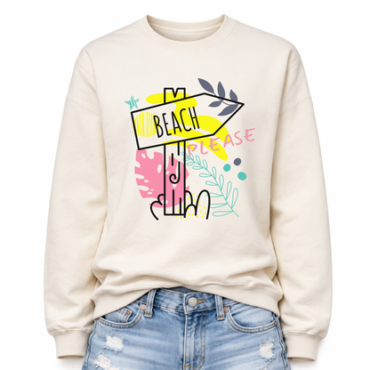 Beach themed graphic on a classic off white crewneck sweatshirt. The design features a stylized beach direction sign with the word Beach centered inside the arrow, surrounded by colorful coastal inspired shapes and decorative elements. The phrase Beach Please is incorporated into the graphic, creating a playful vacation themed design with bright tropical accents.