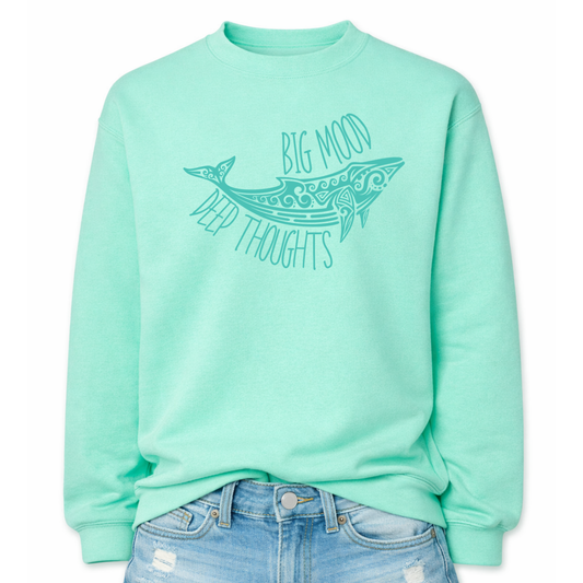 MInt color Coastal ocean themed graphic on a classic mint green crewneck sweatshirt. The design features a large decorative whale illustration filled with detailed swirl and sea life pattern elements. The phrase Big Mood Deep Thoughts is incorporated into the artwork with curved lettering that follows the whale shape, creating a balanced ocean inspired layout.