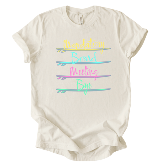 Surf themed beach graphic on a soft heather oatmeal unisex graphic tee. The design features the phrase Mandatory Board Meeting Bye displayed across four stacked surfboards in bright summer colors including yellow, aqua, pink, and seafoam green. A lighthearted beach humor graphic that captures the feeling of skipping work for ocean time.