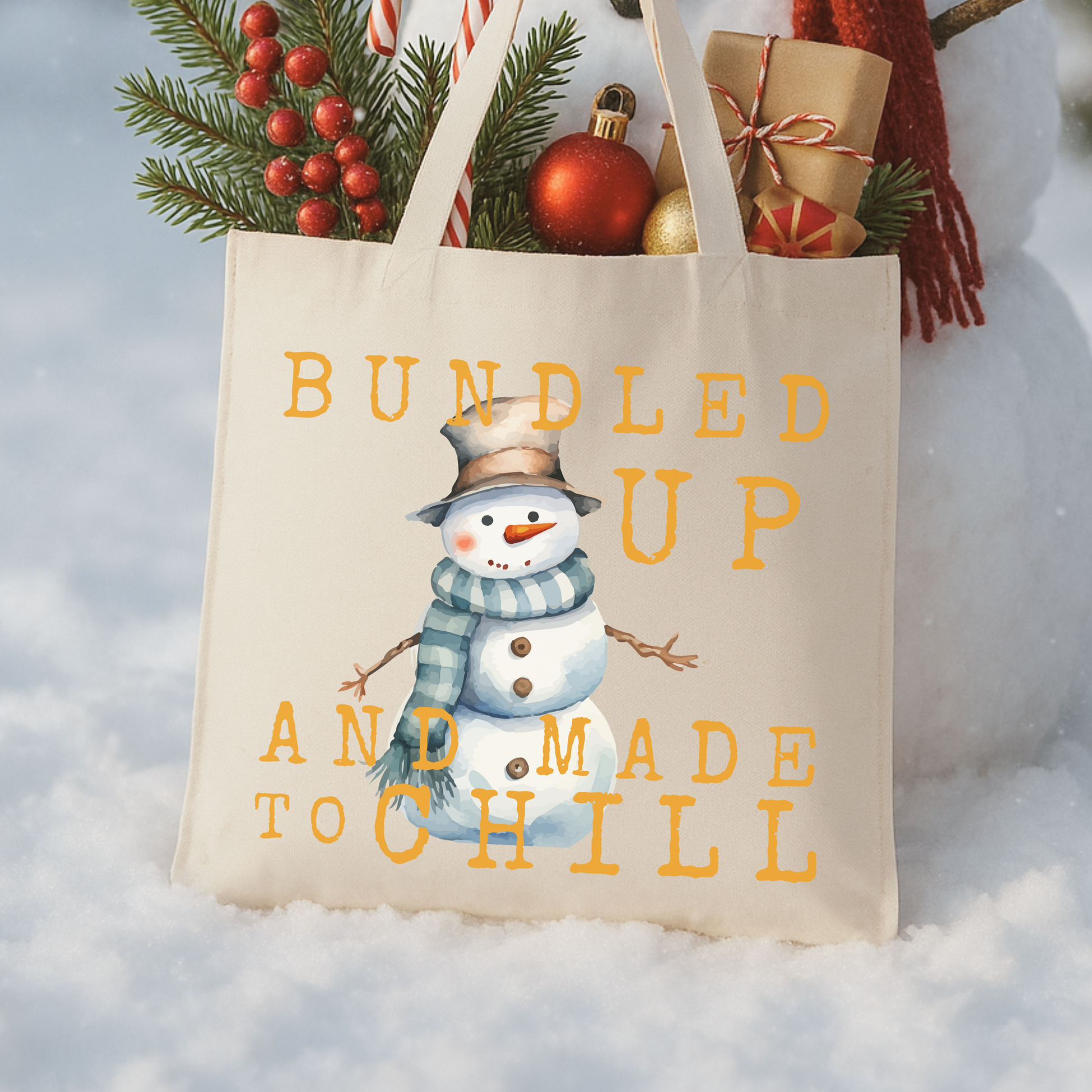 Tote bag with snowman design and text 'Bundled Up and Made to Chill' 
