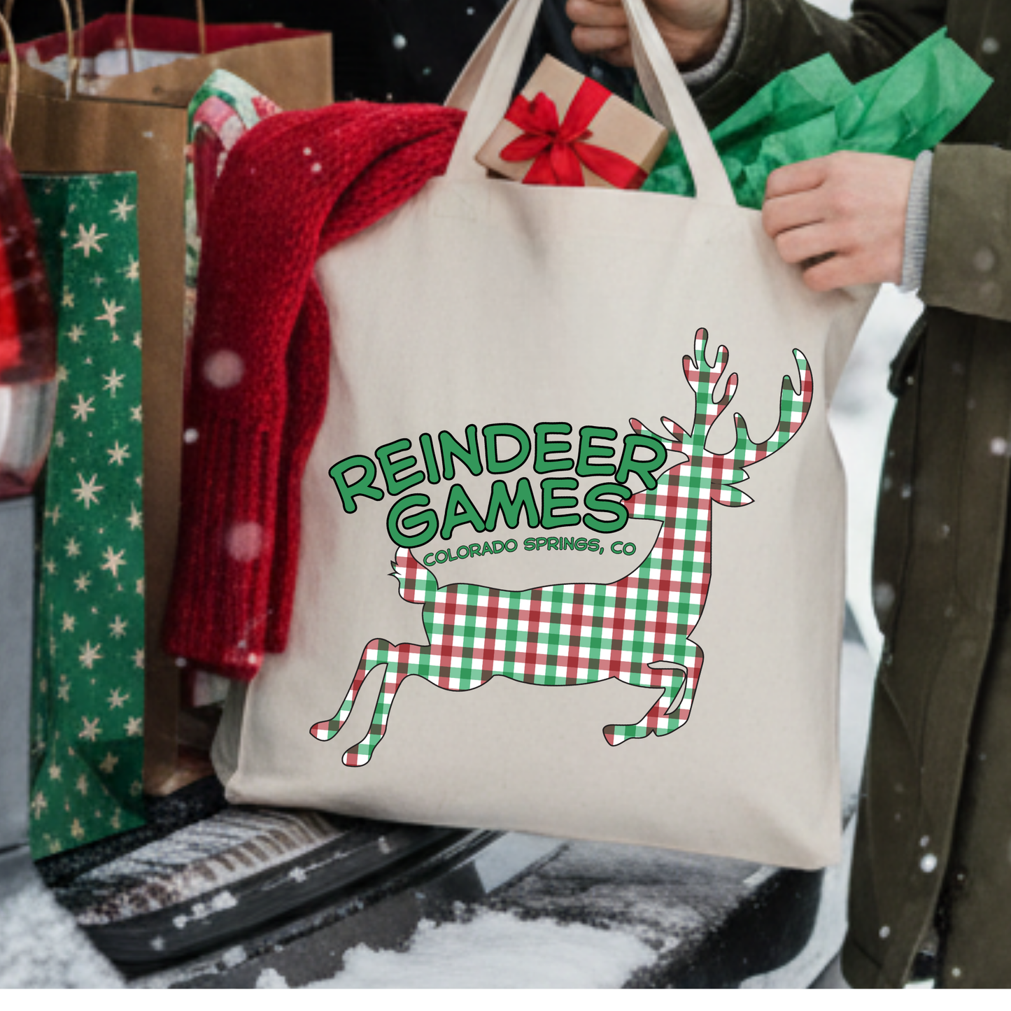 Canvas tote bag with a large red and white checkered reindeer.  Tote says reindeer games.  Customizable tote with business name, city and state or both
