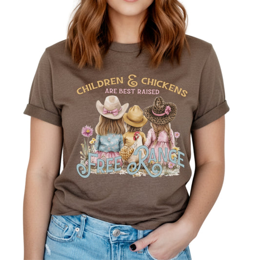 Children and chickens are best raised free range featuring 3 cute kids with a chicken in a flower field. on a heather brown t-shirt