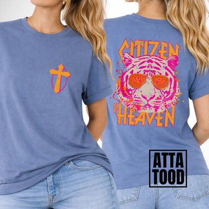 front and back image of a comfort color blue tee.  pocket image is of a pink and mustard cross and the back is a large image that says Citizen of Heaven with a pink tiger wearing sunglasses