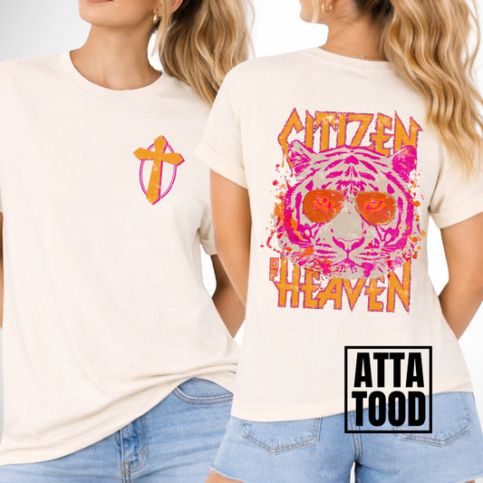 front and back image of a comfort color ivory tee.  pocket image is of a pink and mustard cross and the back is a large image that says Citizen of Heaven with a pink tiger wearing sunglasses