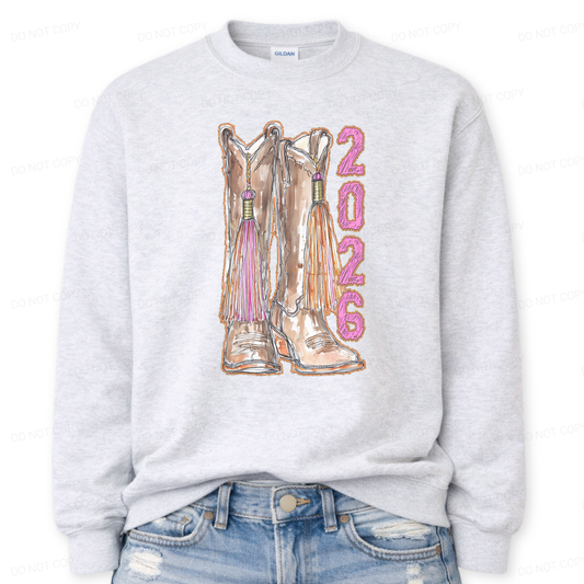 Gray sweatshirt with cowboy boots and '2026' printed on it, worn with blue jeans.