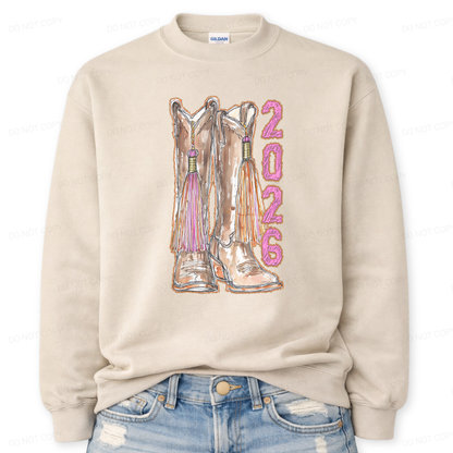 Beige sweatshirt with cowboy boots and '2026' text on a white background