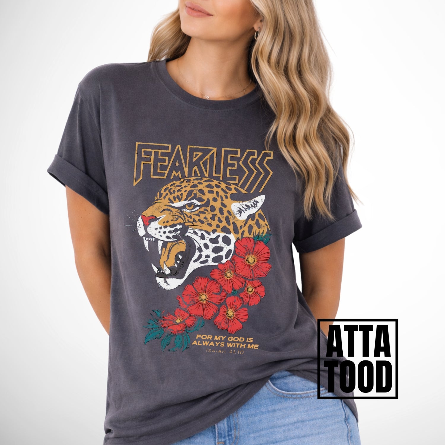Woman wearing a gray comfort colors t-shirt with a leopard and floral design, labeled 'ATTA TOOD'. Fearless for my God is always with me