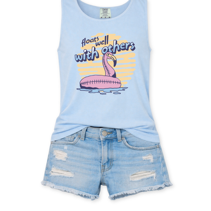 blue tank top with a flamingo floaty graphic design that says floats well with others.