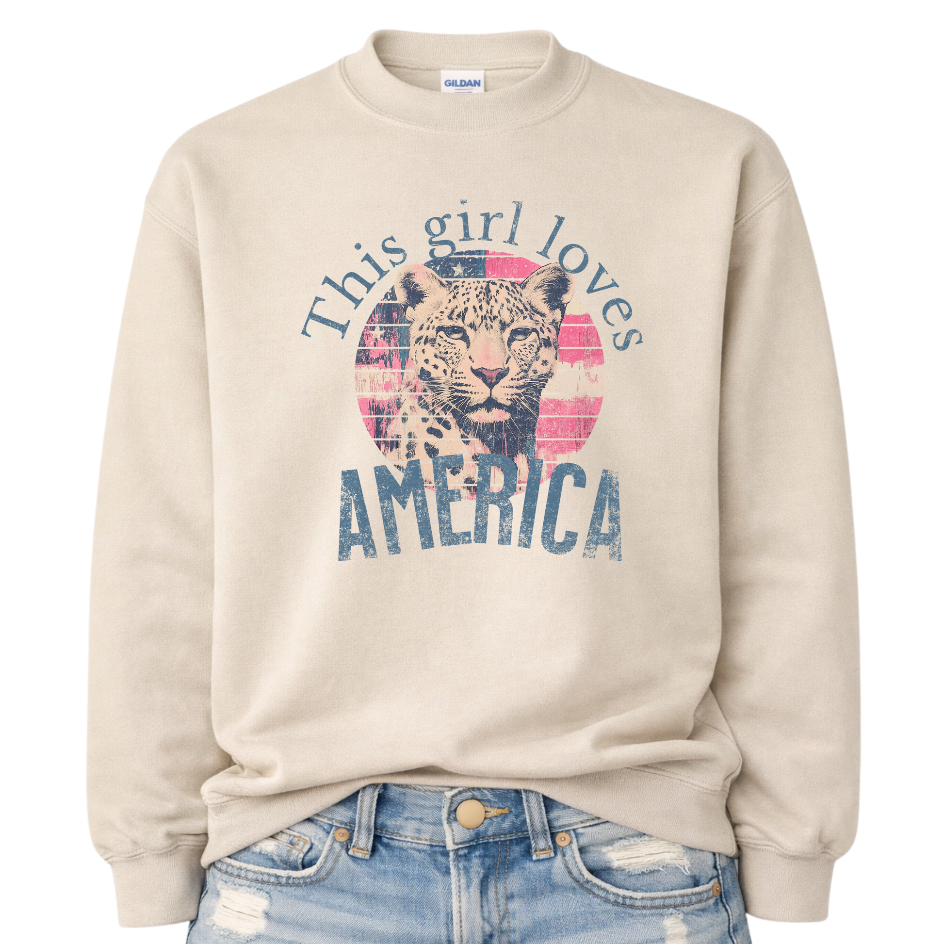 Beige sweatshirt with a graphic of a leopard and text 'This girl loves America' on a white background.