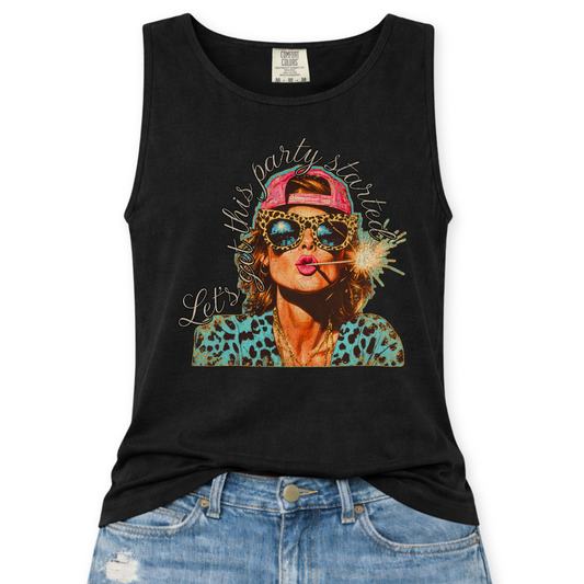 Black Comfort Colors tank top featuring a colorful patriotic graphic of a woman wearing leopard print sunglasses and a pink hat holding a sparkler with the phrase “Let’s Get This Party Started,” styled with light wash denim jeans.