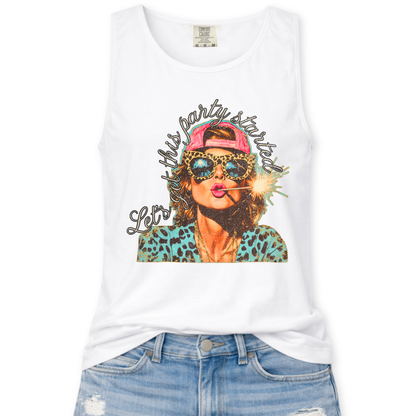 white Comfort Colors tank top featuring a colorful patriotic graphic of a woman wearing leopard print sunglasses and a pink hat holding a sparkler with the phrase “Let’s Get This Party Started,” styled with light wash denim jeans.