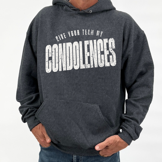 Person wearing a dark gray hoodie with text 'GIVE YOUR TEAM MY CONDOLENCES' on a white background