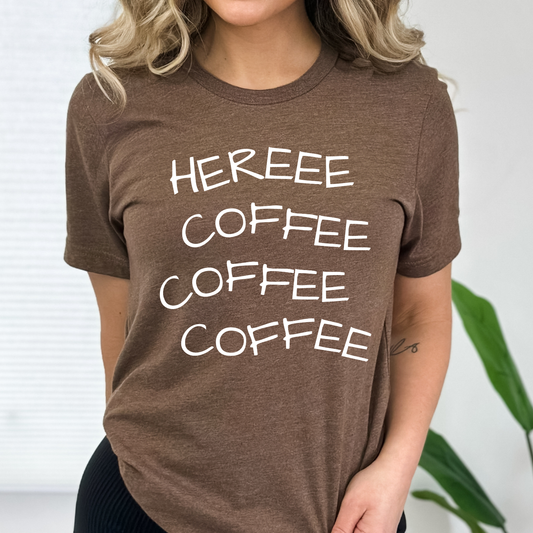 Person wearing a brown t-shirt with 'HEREEE COFFEE COFFEE COFFEE' text.